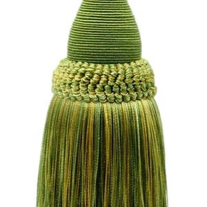 May include: A decorative tassel in shades of green and gold. The tassel features a twisted cord loop, a bulbous body with a gold band, and a full fringe. The design is suitable for home decor.