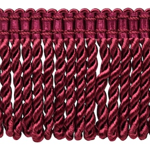 May include: Burgundy red twisted fringe trim with a woven top edge.