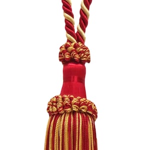 May include: Red and gold tassel with a twisted rope cord. The tassel is made of multiple strands of red and gold thread.