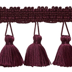 May include: Burgundy tassel trim with a woven top and five tassels. The tassels are approximately 2 inches long.
