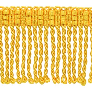 May include: Gold twisted fringe trim with a woven top. This trim is perfect for adding a touch of elegance to any project.