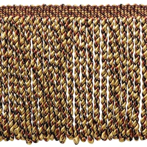 May include: Close-up of decorative fringe with a repeating pattern. The fringe features twisted cords in gold, black, and burgundy. The top edge is a solid burgundy color, and the cords hang vertically.