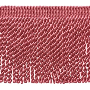 May include: A dusty rose coloured decorative fringe trim featuring a woven horizontal header band with a series of long, vertically hanging twisted cord strands that create a uniform, textured appearance across the entire length of the fabric trim.
