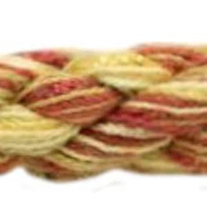 May include: A close-up of a braided rope trim with alternating stripes of cream and peach.