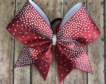 May include: A red and white cheer bow with silver glitter and rhinestones.