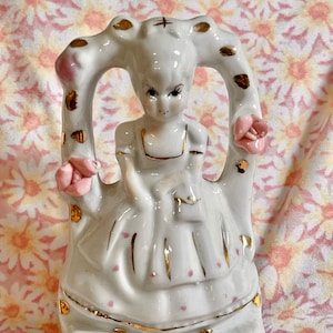 Vintage Little Girl sitting on a swing - White Dress with Gold and Pink AccentThis