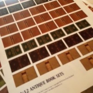 May include: A sheet of paper printed with multiple miniature antique book sets. The books are in various colors, including brown, green, and dark brown. The text "1:12 Antique Book Sets" is printed at the bottom of the page.