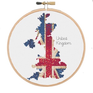 May include: A cross-stitch embroidery of the United Kingdom, depicting the Union Jack flag. The map is stitched in red, white, and blue, set against a white background within a wooden embroidery hoop. The words "United Kingdom" are written in a cursive font.
