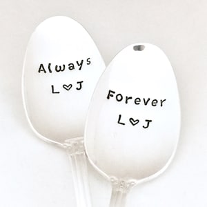 May include: Two silver spoons with the words "Always L♥J" and "Forever L♥J" engraved on them.