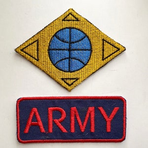 May include: Two embroidered patches. The top patch is yellow with a blue globe and four black triangles. The bottom patch is navy blue with red text that reads "ARMY".