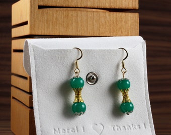 Earrings made of glass beads in the color ''jade green'' with golden ornaments. Unique model in limited quantity!