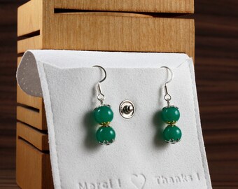 Earrings made of glass beads in the color ''jade green'' with golden ornaments. Unique model in limited quantity!