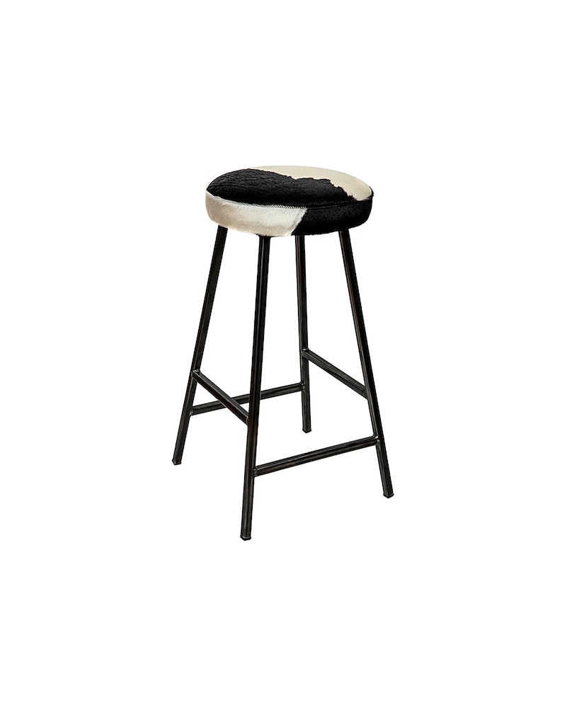 May include: A black metal bar stool with a round, black and white cowhide seat.