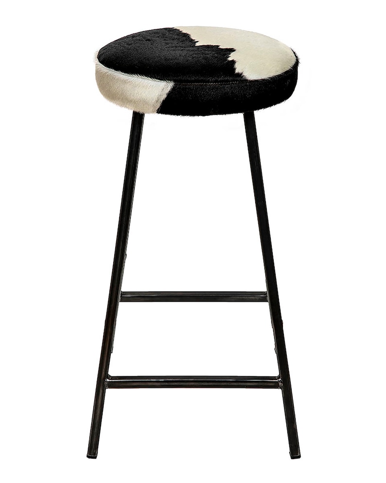 May include: Black and white cowhide bar stool with a black metal frame.
