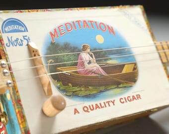 3 String Electric Cigar Box Guitar in a very old Cigar Box