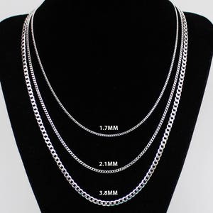 May include: Three silver chains of different thicknesses, displayed on a black background. The chains are labelled with their thickness in millimetres: 1.7mm, 2.1mm, and 3.8mm.