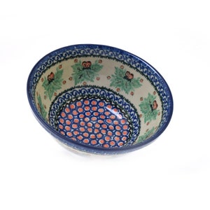 May include: A blue and white ceramic bowl with a floral pattern and a red and white polka dot design. The bowl is perfect for serving salads, soups, or desserts.