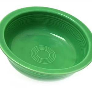 May include: A green ceramic bowl with a wide rim and a concentric circle design in the bottom.
