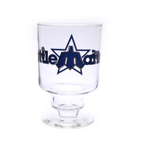 May include: A clear glass with a star and the text "Little Man" in gold lettering. The star is blue and the glass has a stemmed base.