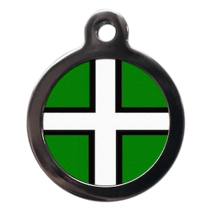 May include: A round, silver pet tag with a green and white cross design. The tag has a black border and a silver ring for attaching to a collar.