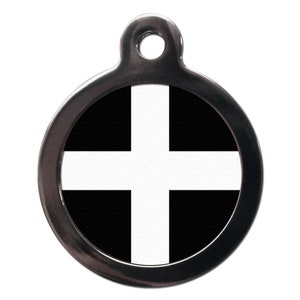May include: A round silver pet tag with a black and white cross design. The cross is white and the background is black.