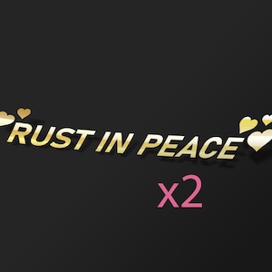May include: Gold text on a black background that reads "RUST IN PEACE x2" with gold hearts surrounding the text.