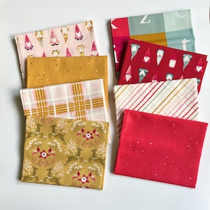 Art Gallery Fabrics Christmas Fat Quarter Mini Bundle—Adventale--8 Fat Quarters in shades of pink, red, gold, and blue.