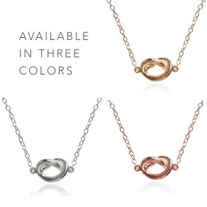 May include: Three gold, silver, and rose gold knot necklaces.  Available in three colors.