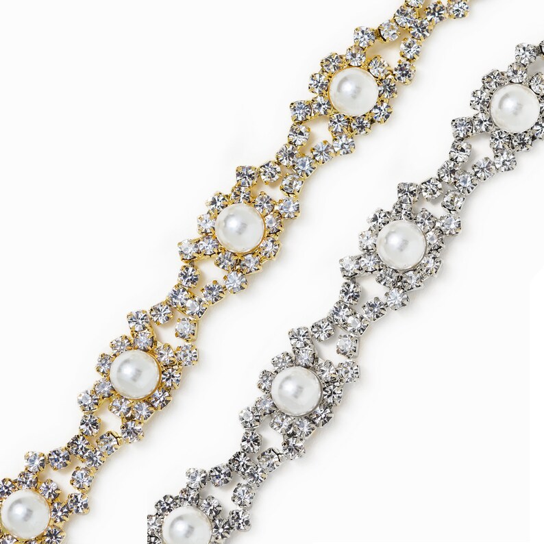 May include: Two strands of rhinestone trim with faux pearl accents. One strand is gold and the other is silver.