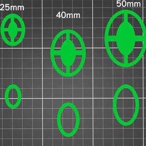 May include: Four green circle-shaped cookie cutters with a cross design in the center. The cutters are 25mm, 40mm, and 50mm in diameter. The cutters are on a black and white grid background.