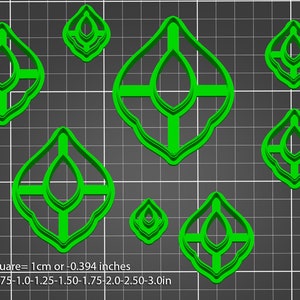 May include: Set of seven green plastic cookie cutters in various sizes, shaped like a stylized leaf with a teardrop in the center. The cutters are arranged on a gray grid background. 1 Square = 1 cm or 0.394 inches. Sizes shown: .75-1.0-1.25-1.50-1.75-2.0-2.50-3.0 in.