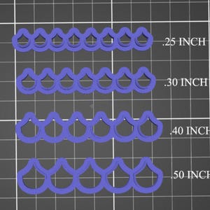 May include: Four rows of purple plastic lace trim with scalloped edges. The trim is shown in four different sizes: 0.25 inch, 0.30 inch, 0.40 inch, and 0.50 inch.