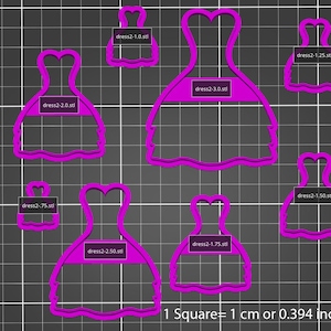 May include: Set of 8 pink plastic cookie cutters shaped like a dress in various sizes. The cutters are on a black and white grid background. The text "1 Square = 1 cm or 0.394 inches" is at the bottom of the image.