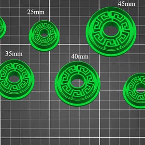 May include: Set of six green plastic cookie cutters with a Greek key design. The cutters are 20mm, 25mm, 30mm, 35mm, 40mm, and 45mm in diameter.