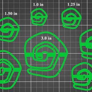 May include: Green spiral shapes of varying sizes, ranging from 1.0 to 3.0 inches in diameter, are displayed on a dark gray grid background. The shapes are outlined in bright green, with measurements in inches next to each spiral.