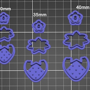 May include: Set of six purple plastic cookie cutters in three sizes: 30mm, 35mm, and 40mm. The cutters are shaped like strawberries and flowers.