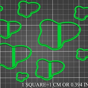 May include: Set of seven green cookie cutters in various irregular shapes, including butterflies with a vertical line down the center.  1 square = 1 cm or 0.394 inches.