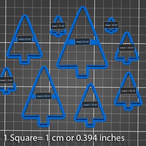 May include: Nine blue plastic Christmas tree cookie cutters of varying sizes, ranging from 0.75 inches to 3 inches in width. The cutters are arranged on a gray grid background with the text "1 Square = 1 cm or 0.394 inches".