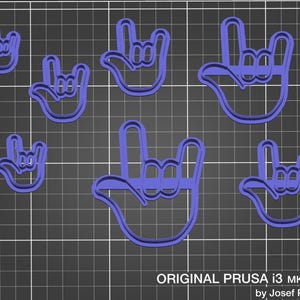 May include: Several blue plastic hand-shaped cookie cutters, arranged on a grid. The hand gestures are in the "I love you" sign. The text "ORIGINAL PRUSA i3 MK3 by Josef Prusa" is at the bottom.