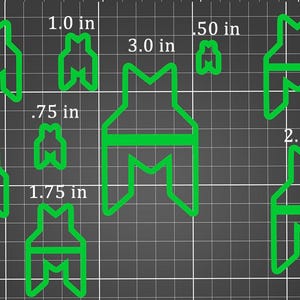 May include: A collection of green, geometric-shaped cookie cutters in various sizes, ranging from 0.50 inches to 3.0 inches. The shapes are displayed against a gray grid background, with measurements in inches.