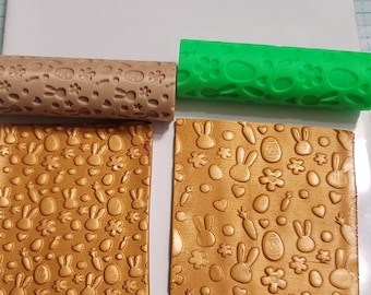 May include: Two rolling pins with Easter-themed designs. The rolling pins are made of silicone and have a brown and green color. The designs include bunnies, eggs, carrots, and flowers.