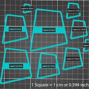 May include: A set of eight turquoise blue organic-shaped stencils with measurements in centimetres. The stencils are arranged on a black grid background. The text "1 Square = 1 cm or 0.394 inches" is at the bottom of the image.