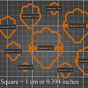 May include: A set of ten flower petal cookie cutters in various sizes, ranging from 0.75 inches to 3.0 inches in diameter. The cutters are made of orange plastic and are arranged on a gray grid background. The text "1 Square = 1 cm or 0.394 inches" is printed below the cutters.