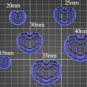 May include: A set of six purple, shell-shaped cookie cutters arranged on a grid. The cutters are labeled with sizes of 15mm, 20mm, 25mm, 30mm, 35mm, and 40mm. Each cutter features a scalloped edge and a central ribbed design for creating detailed shapes.