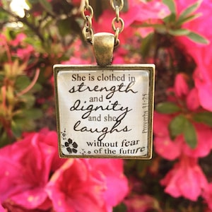 Bible Verse Pendant Necklace &quot;She is clothed in strength and dignity and she laughs without fear of the future. Proverbs 31:25&quot;