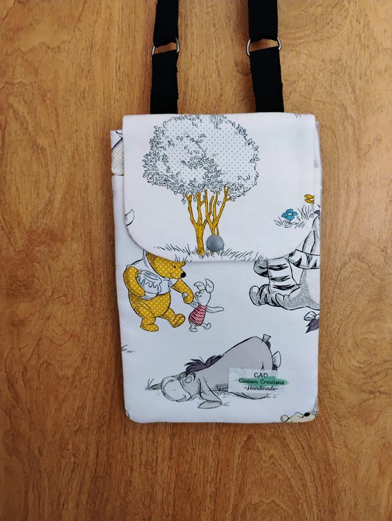 Winnie the Pooh crossbody cellphone bagwith extra storage pouch.