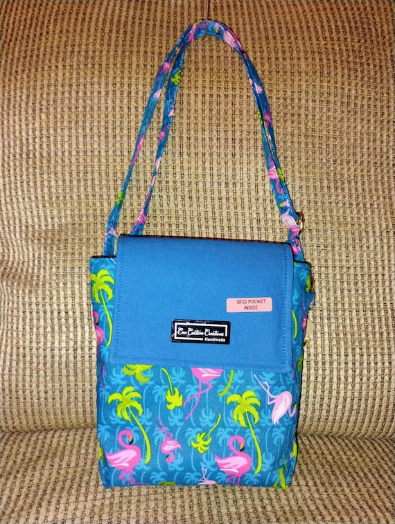 Flamingos on a blue and pink mid-sized purse.