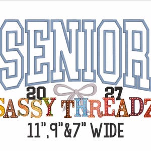 May include: A white background features the word "SENIOR" in light blue outlined letters above "2027" and "SASSY THREADZ" in colorful letters. A gray bow is between the numbers and the text. The text at the bottom reads "11", 9" & 7" WIDE".