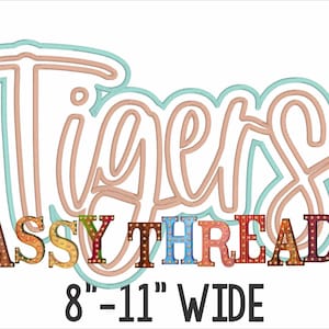 May include: A colorful, multi-layered, cursive word art design of "Tigers" with a peach and teal outline. The word "Tigers" is above the text "SASSY THREADZ" in colorful block letters with a light bulb design. The text "8" - 11" WIDE" is below the design.