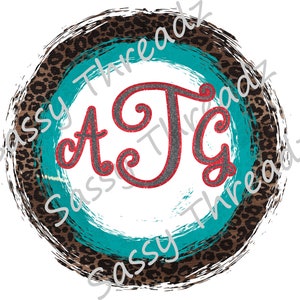 May include: Circular design with a white center, teal and leopard print accents, and a distressed brown border. The letters "ATG" are in the center, with a red outline and a gray glitter fill.